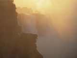 Mist Over Victoria Falls at Sunrise, Zimbabwe Photographic Print by Jim Zuckerman