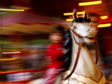 Child on Carousel at Grona Lund Amusement Park, Stockholm, Sweden Photographic Print by Nancy & Steve Ross