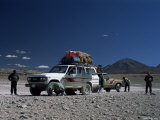 Landcruisers and Tourists on Jeep Tour Taking a Break on Uyuni Salt Flat, Bolivia, South America Photographic Print by Aaron McCoy