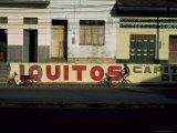Bicycle Cruises Past Homes, Iquitos, Peru, South America Photographic Print by Aaron McCoy