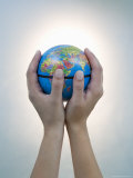Woman's Hands Holding World Globe Photographic Print by Angelo Cavalli