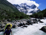 Backpacker Crossing Bridge in the Valle Frances, South America Photographic Print by Aaron McCoy