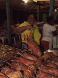 Local Woman Selling Lobsters at the Seafood Friday Night, Anse La Raye, St. Lucia, West Indies Photographie par Yadid Levy