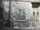 Bicycle Leaning against a Stone House in Ravenna, Italy Photographic Print by Gina Martin
