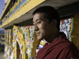 Buddhist Monk near the Edge of a Painted Stupa, Qinghai, China Photographic Print by David Evans