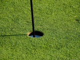 Close View of a Flag Pole in a Hole on a Golf Course, Groton, Connecticut Photographic Print by Todd Gipstein