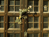 Flowers on the Wooden Door of a Mausoleum in a Cemetery, Italy Photographic Print by Todd Gipstein