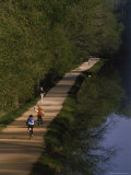 Bikers on the C and O Canal Path in Washington, D.C. Photographic Print by Phil Schermeister