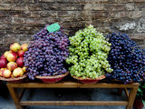 Grapes and Nectarines on a Bench at a Siena Market, Tuscany, Italy Photographic Print by Todd Gipstein