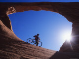 Mountain Biker Stands under an Arch Photographic Print by Bill Hatcher