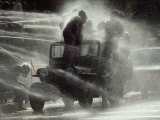 Jeep Full of Innocent Onlookers is Sprayed with Water During the Water Festival Lámina fotográfica por James L. Stanfield