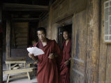Monks at a Doorway Taking a Break from their Studies, Qinghai, China Photographie par David Evans