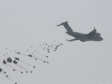 Paratrooper Supplies Deployed from the Back of C-140 Cargo Plane Photographie par Skip Brown