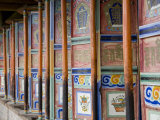 Prayer Wheels in a Row at a Buddhist Monastery in Qinhai, China Photographie par David Evans