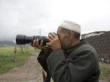 Muslim Rural Resident Looks Through a Camera, Qinghai, China Photographic Print by David Evans