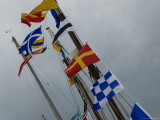 Nautical Flags Hanging from the Wooden Mast of a Sailing Ship, Mystic, Connecticut Photographic Print by Todd Gipstein