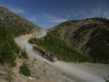 Log Trucks Carry Old Growth Logs Down a Mountain Fotoprint van James P. Blair Log Trucks Carry Old Growth Logs Down a Mountain Fotoprint van James P. Blair