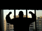 The Sun Silhouettes a Man Showing Off his Strength in Washington, D.C. Photographie par Joel Sartore