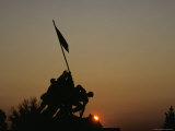 The Iwo Jima Memorial Silhouetted by a Setting Sun, Washington, D.C. Photographic Print by Kenneth Garrett