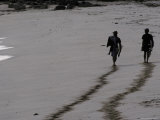 The Silhouette of Two Surfers and their Foot Prints on a Sandy Beach, Australia Photographic Print by Jason Edwards