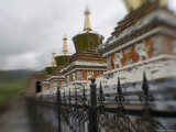 Stupas Behind a Wrought Iron Fence at a Monastery, Qinghai, China Photographie par David Evans