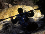 Silhouette of Man Kayaking Through Flooded Canyon Photographic Print by Kate Thompson