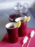 Two Beakers of Fruit Tea with Lemon Wedges, Sugar Sticks Photographie par Anita Oberhauser