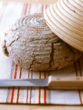 Wholewheat Bread with Round Bread Tin and Knife Photographic Print by Jörn Rynio