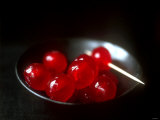Cocktail Cherries in a Black Bowl Photographic Print by Michael Paul