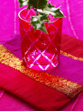 Sprig of Holly in Festive Red Glass on Cushion Photographic Print by Joff Lee