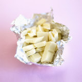 Broken White Chocolate in Aluminium Foil Photographic Print by Dave King