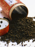 Tea Leaves Tipped out in Front of Tea Box Photographic Print by Joerg Lehmann