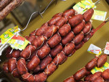Chorizo, Red Paprika Sausage (Spain), Hanging up for Sale Photographic Print by Christopher Leggett