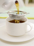 Pouring Tea Through a Tea Strainer Photographic Print by Winfried Heinze