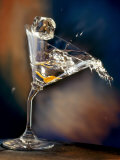 Vodka Martini Spilling from a Bent Martini Glass with Ice Cube Photographic Print by Jeff Sarpa
