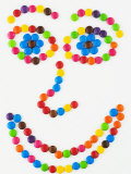 Coloured Chocolate Beans Forming a Smiling Face Fotografisk tryk af Greg Elms