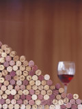 Wine Corks, Piled Up, and a Glass of Red Wine Photographic Print by Henrik Freek