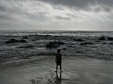 Child Standing at the Edge of Tide Photographic Print by Krzysztof Rost