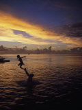 Father Playfully Throwing Son in Water Photographic Print by Barry Winiker