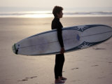 Surfer on a Beach, North Devon, England Photographie par Lauree Feldman
