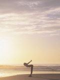 Woman Stretching on Beach at Sunrise Photographic Print by Kevin Radford