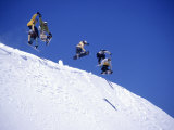 Snowboarders Jumping off Overhang, CO Photographic Print by Kurt Olesek