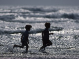 Two Children Running at the Beach Photographic Print