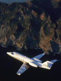 Lear Jet in Flight Over Mountains Photographic Print by Garry Adams