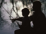 Silhouette of Father and Five-year-old Son Fishing Photographic Print by Kevin Beebe