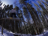 Man Riding Log on Snowboard, Vail, CO Photographic Print by Kurt Olesek