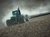 Tractor in Dusty Field Photographic Print