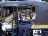 Man Uses Laptop in Back Seat of Rickshaw, India Photographic Print by Steve Starr