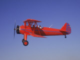 Red Bi-Plane in Flight Photographic Print by Larry McManus