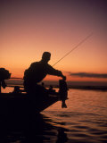 Silhouette of Bass Fisher at Sunset Photographie par Timothy O'Keefe